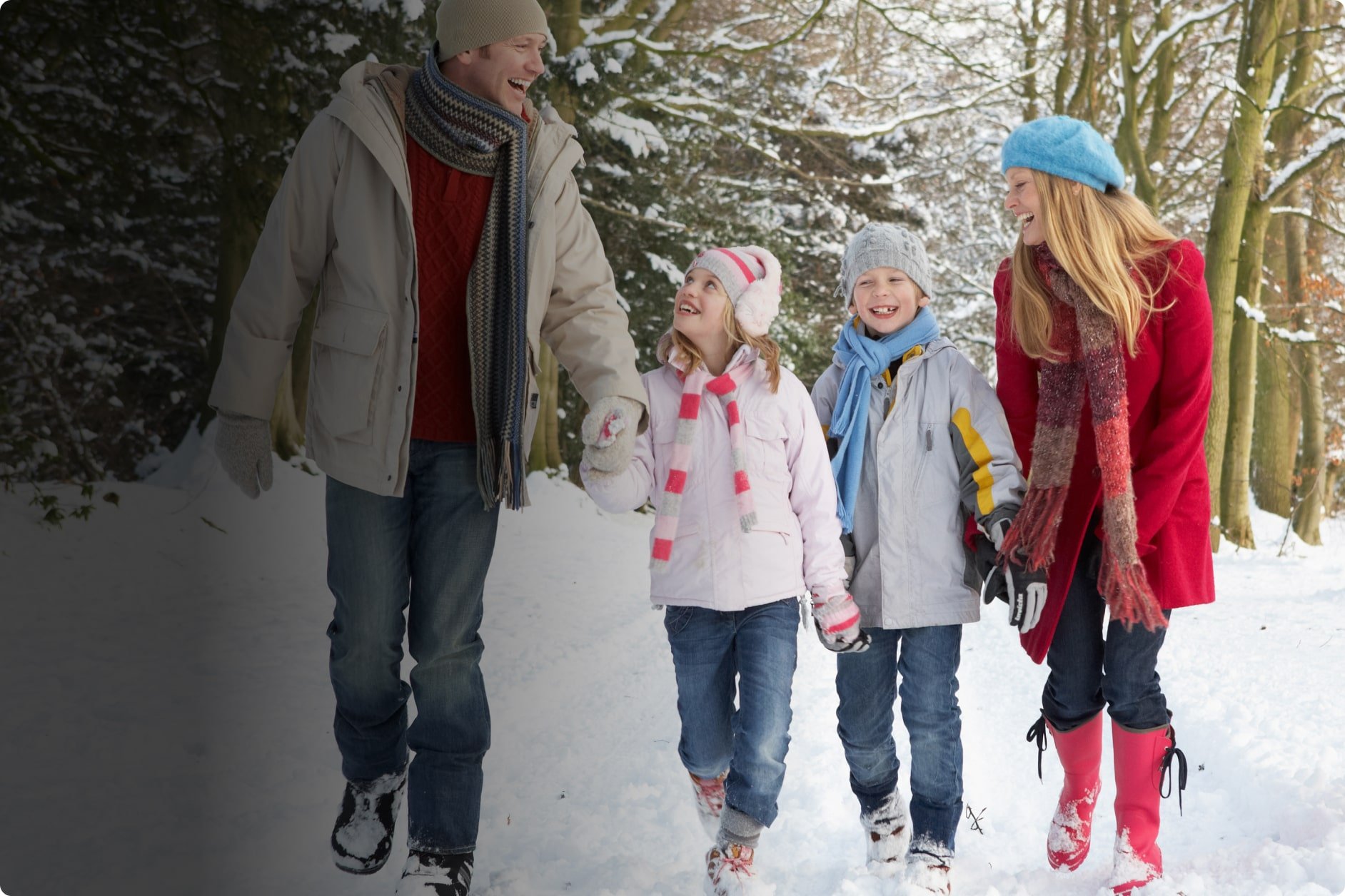 family walking in the snow